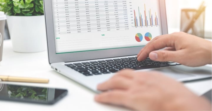 Person reviewing financial charts on a laptop