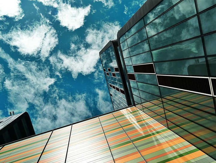 Looking up at a glass office building
